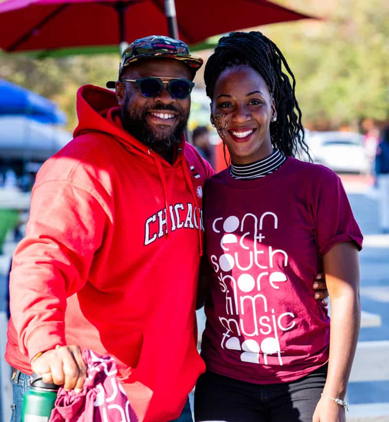 Smiling man and woman at South Shore CDC community event.